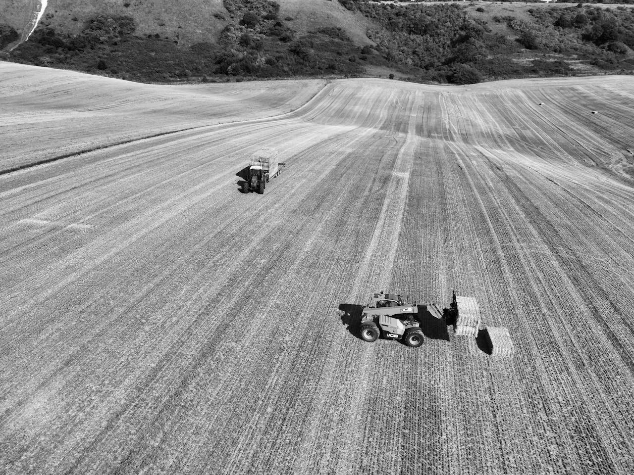 Mastering the First Impression: Your intriguing post title goes here Black and white aerial view of farming machinery in an English field highlighting rural agriculture.